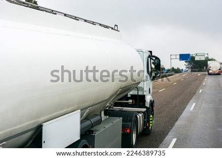 Similar – Foto Bild Zwei Tanklastzüge überqueren eine Autobahn über eine Brücke, Luftaufnahme.