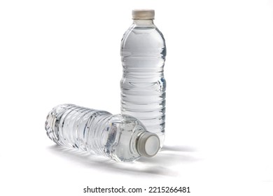 Two full, disposable, single use plastic water bottles isolated on white