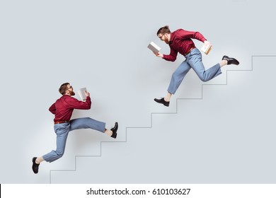 Two funny bearded twin men and books running up   down along drawn stairs concrete wall