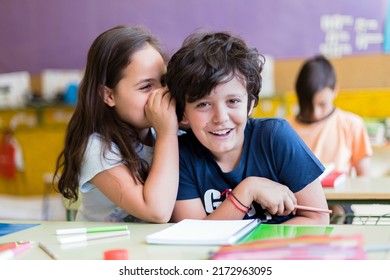 Two Funny Caucasian Children Talking To Each Other In Class. Primary Education. Back To School Concept.