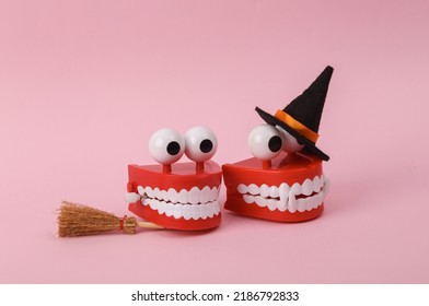 Two Funny Lhalloween Clockwork Jumping Teeth Toy On Pink Background.
