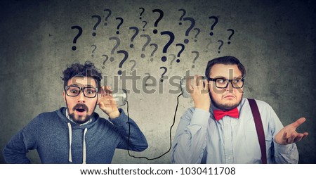 Two funny looking men having troubled communication 