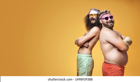 Two funny men wearing swimming shorts, vacation concept