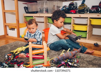 Two Funny And Messy Baby Brothers Playing Together In Kids Room