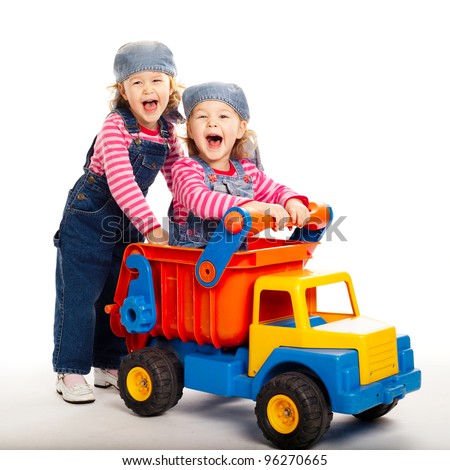 two funny twins girls with toy car