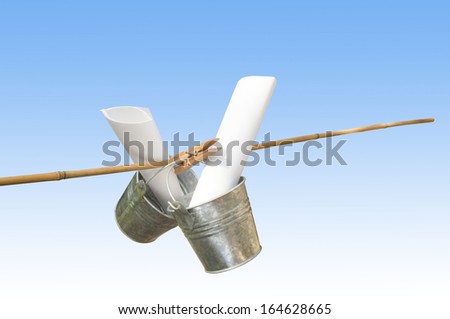 two galvanized buckets pegged on bamboo stick with blue background