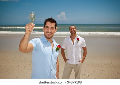 Two gay man after wedding ceremony, one holding glass with the word "groom"