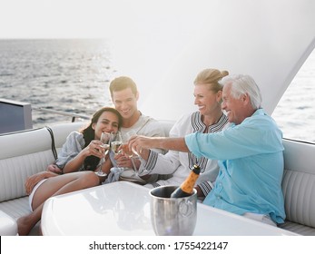 Two generational family celebrating with champagne on yacht - Shutterstock ID 1755422147