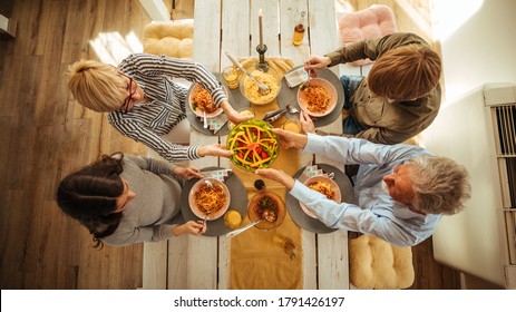 Two Generational Family Enjoying Lunch Together At Home. View From Above