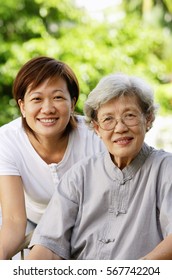 Two generations of women, smiling at camera