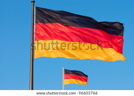 Two german flags flying in the wind