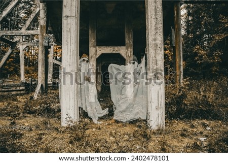 Two ghoulish ghosts posing for the camera