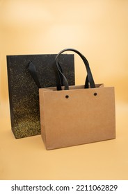 Two Gift Paper Bags On A Textured Yellow And Brown Background