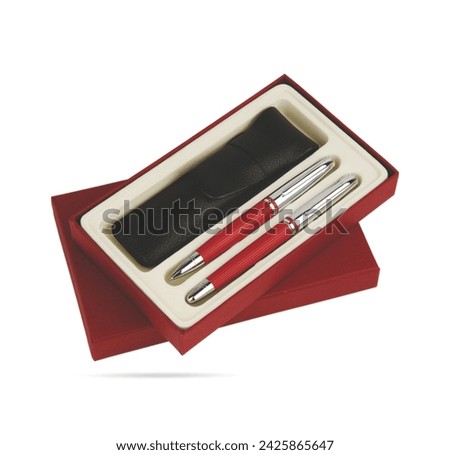 Two gift pens in classy, opened soft plastic or paper pencil box. Gift box packaging for promotional branding. Promotional gift twin red colored metal pens and black leather case in box. 