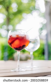 Two Gin And Tonic Cocktails On A Table In A Sunny Garden