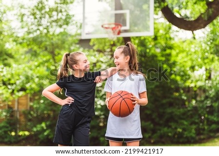 the two girl child in sportswear playing basketball game