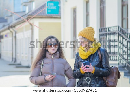 Similar – Image, Stock Photo Twin sisters take pictures of each other with smartphone at a bridge railing