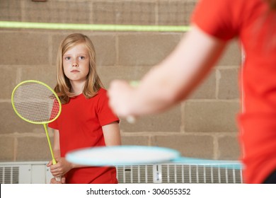 Two Girl Playing Badminton In School Gym