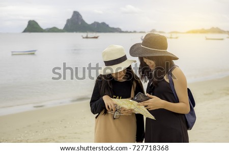 two girl sister looking map during travel