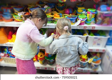 Two Girlfriends Choosing   Gift In   Toy Store