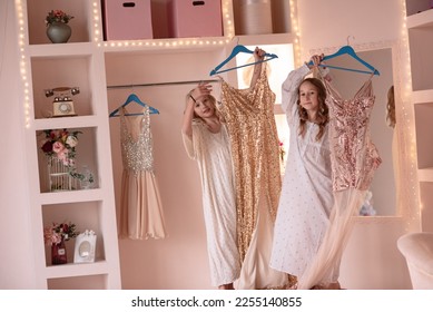 Two girlfriends in the dressing room dress up, playfully pose for a photo. Pajama party . Friendship girls. Little girls love to dress up. The concept of rest and play. - Shutterstock ID 2255140855