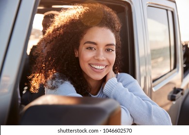 Two Girlfriends Driving With Sunroof Open, One Turning Round