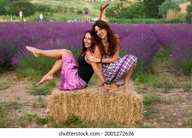 Two Girlfriends Laughing And Joking A Around In A Lavender Field