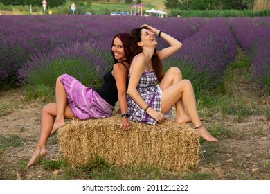 Two Girlfriends Laughing And Joking A Around In A Lavender Field