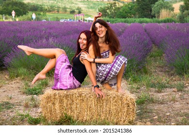 Two Girlfriends Laughing And Joking A Around In A Lavender Field