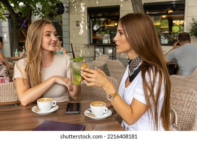 Two Girlfriends Talking In A Outside Cafe Bar