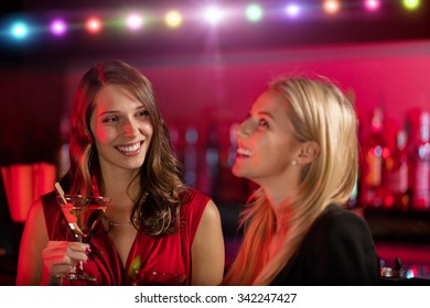 Two Girls At The Bar With Cocktail Drink, Having Fun