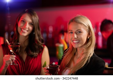 Two Girls At The Bar With Cocktail Drink, Having Fun