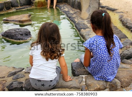 two girls by the pond