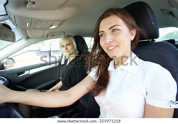 two girls in the\
car