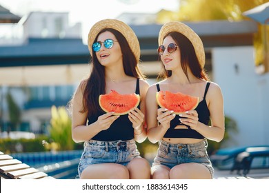 Two Girls Eating Watermelon By The Pool In Thailand