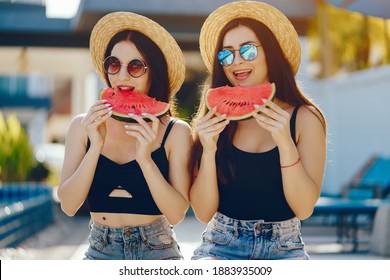 Two Girls Eating Watermelon By The Pool In Thailand