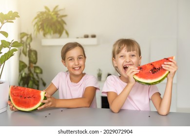 Two Girls Eating Watermelon Isolated At Home