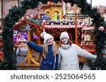 Two girls enjoy on Christmas market in Wroclaw, Poland 