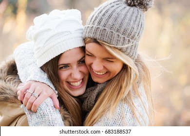 Two Girls Friends With Hats Hugging. Autumn.