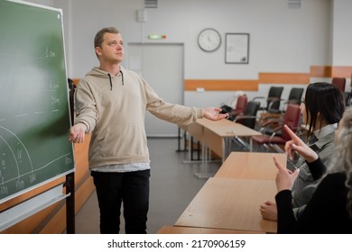 Two Girls And A Guy Are Talking In Sign Language. Three Deaf Students Chatting In A University Classroom.