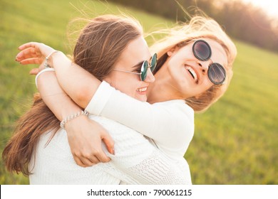 Two Girls Hugging Outdoors. Best Friends