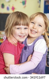 Two Girls Hugging At Pre School