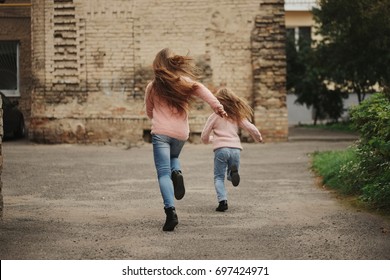 Two Girls With Long Hair Running Away