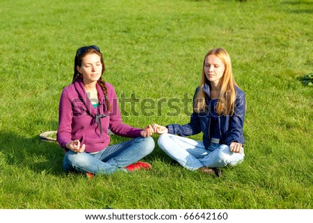 Two girls meditating