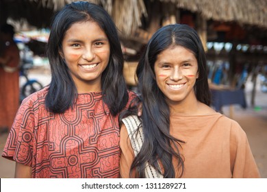 Two girls from the Peruvian jungle pose smiling for the camera. July 03, 2015 Chanchamayo. Peru.