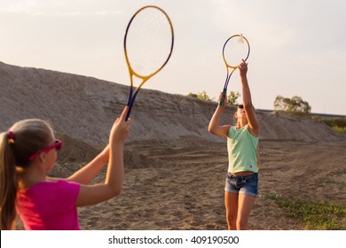 two girls playing badminton outdoor