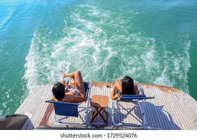 two girls relaxing on yacth at the sea