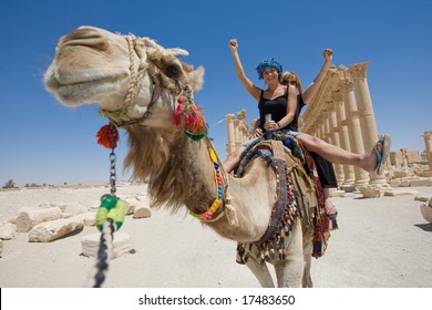 Two Girls Are Ride On Camel In Desert