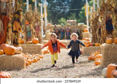 Two Girls Running At The Pumpkin Patch