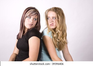 Two Girls Snarling At Each Other With Mean Face Expressions